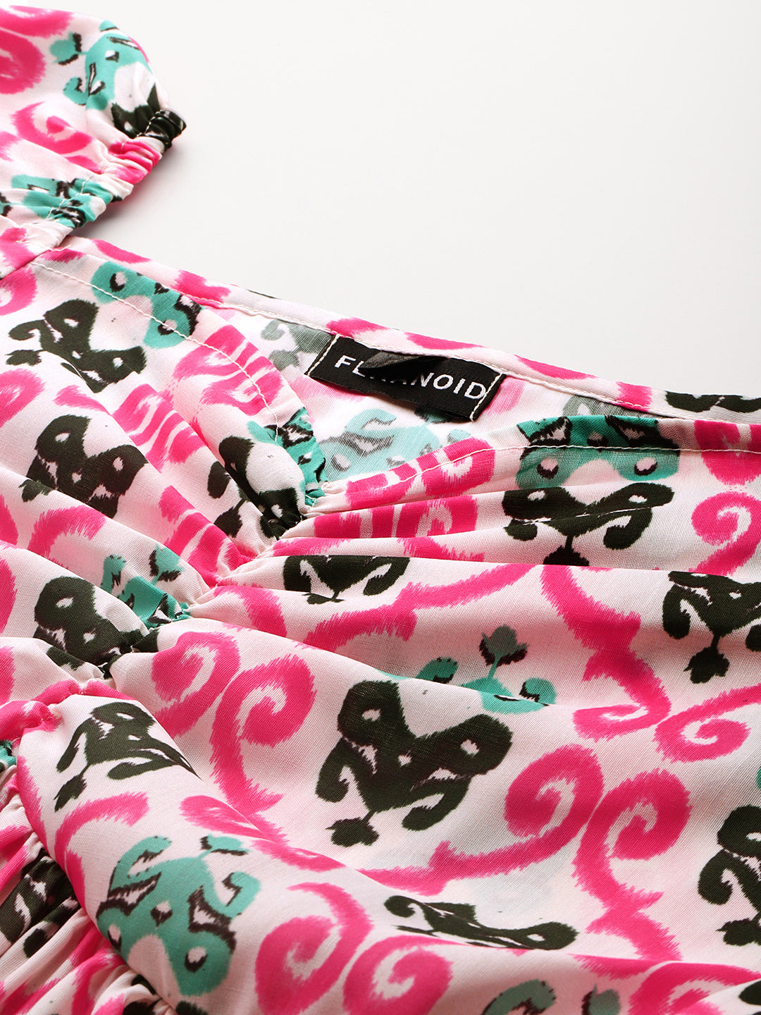 Cropped v-neck peplum puff sleeved top with digital print on linen fabric.