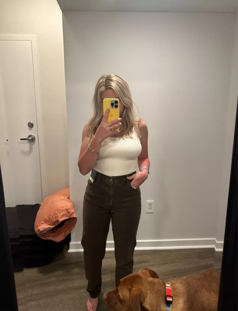 “Curvy model wearing Abercrombie Curve Love high-rise jeans with tucked-in blouse”