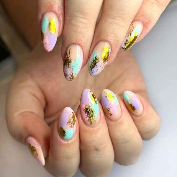 “Abstract nail art on short nails with colorful swirls and irregular brushstroke patterns.”