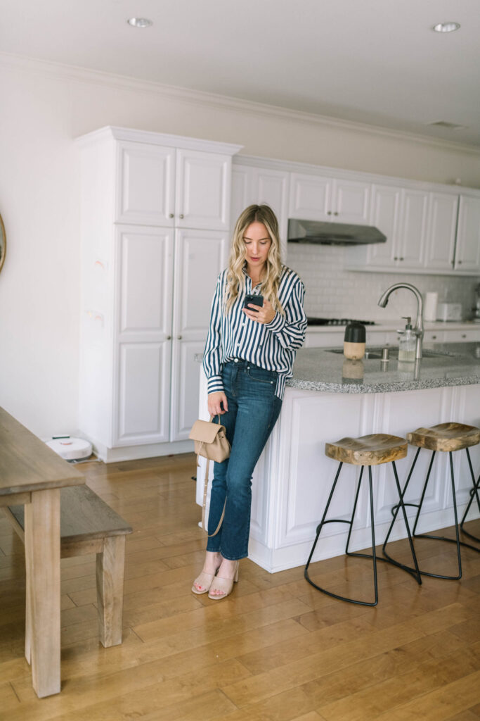 “Curvy woman posing in Good American Good Legs skinny jeans with confident smile”