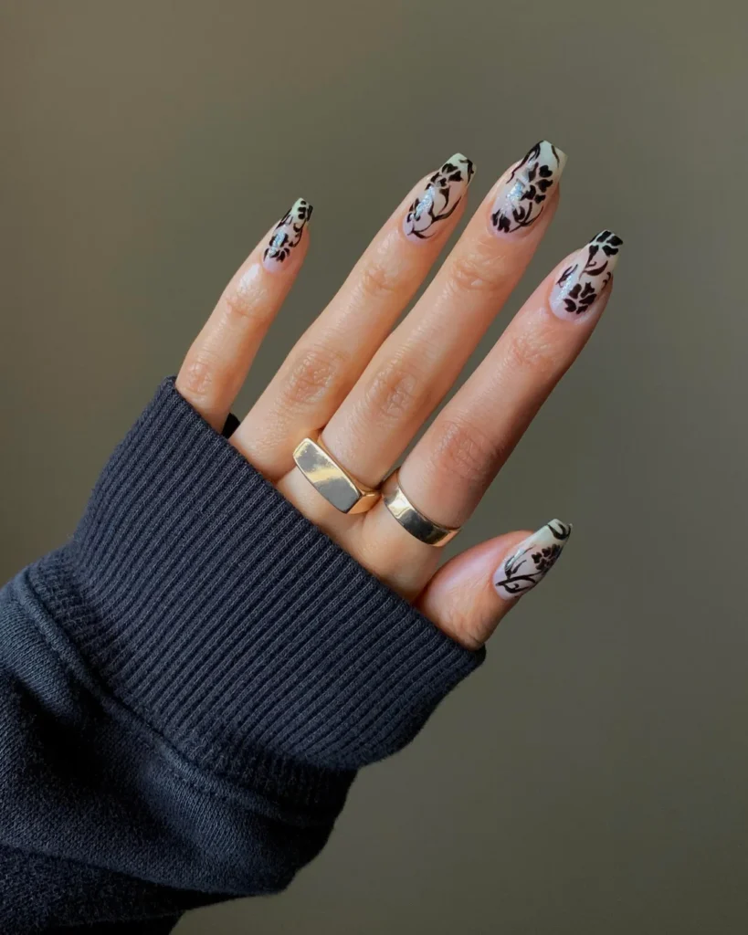 “Short nails with negative space nail art showing geometric transparent sections.”
